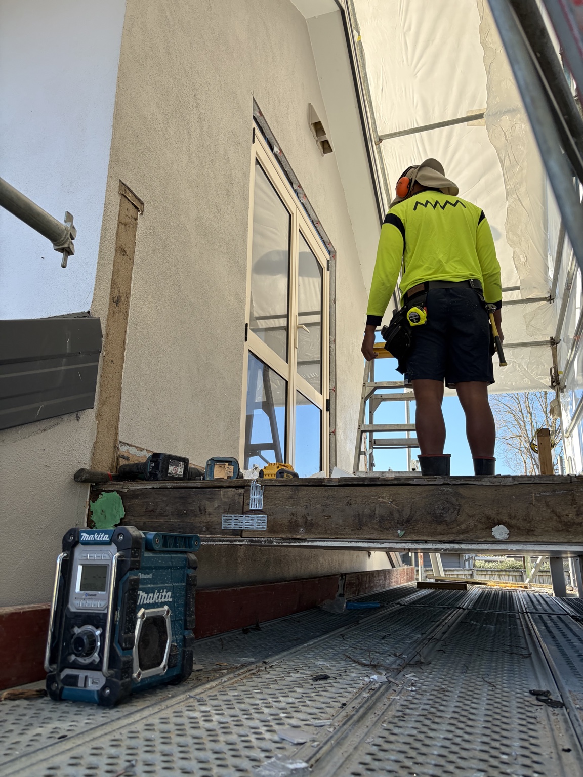 GRIT worker at the upper-level wall during site preparation