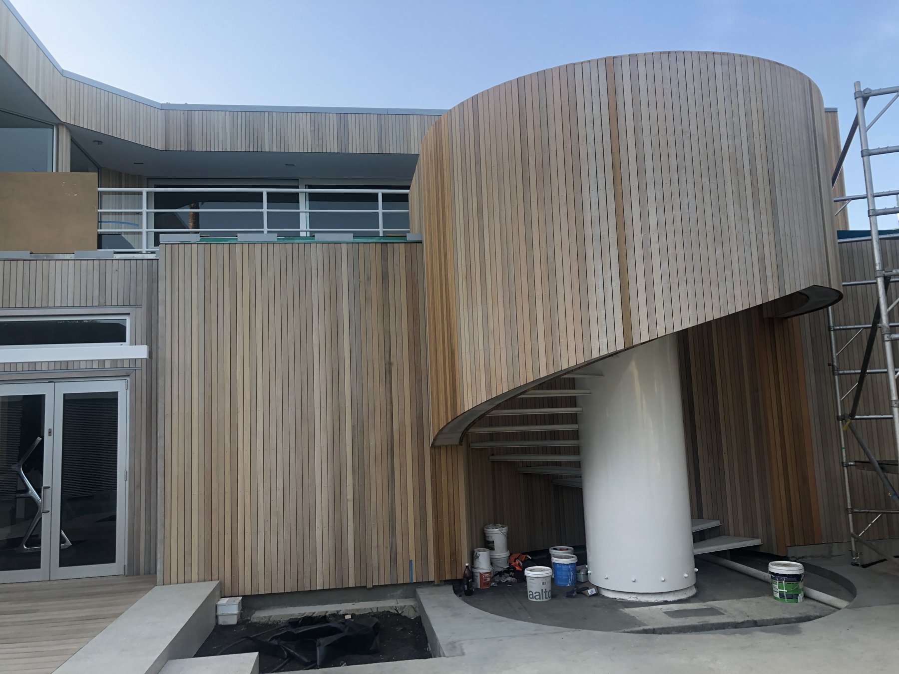 Curved exterior clad in vertical cedar boards