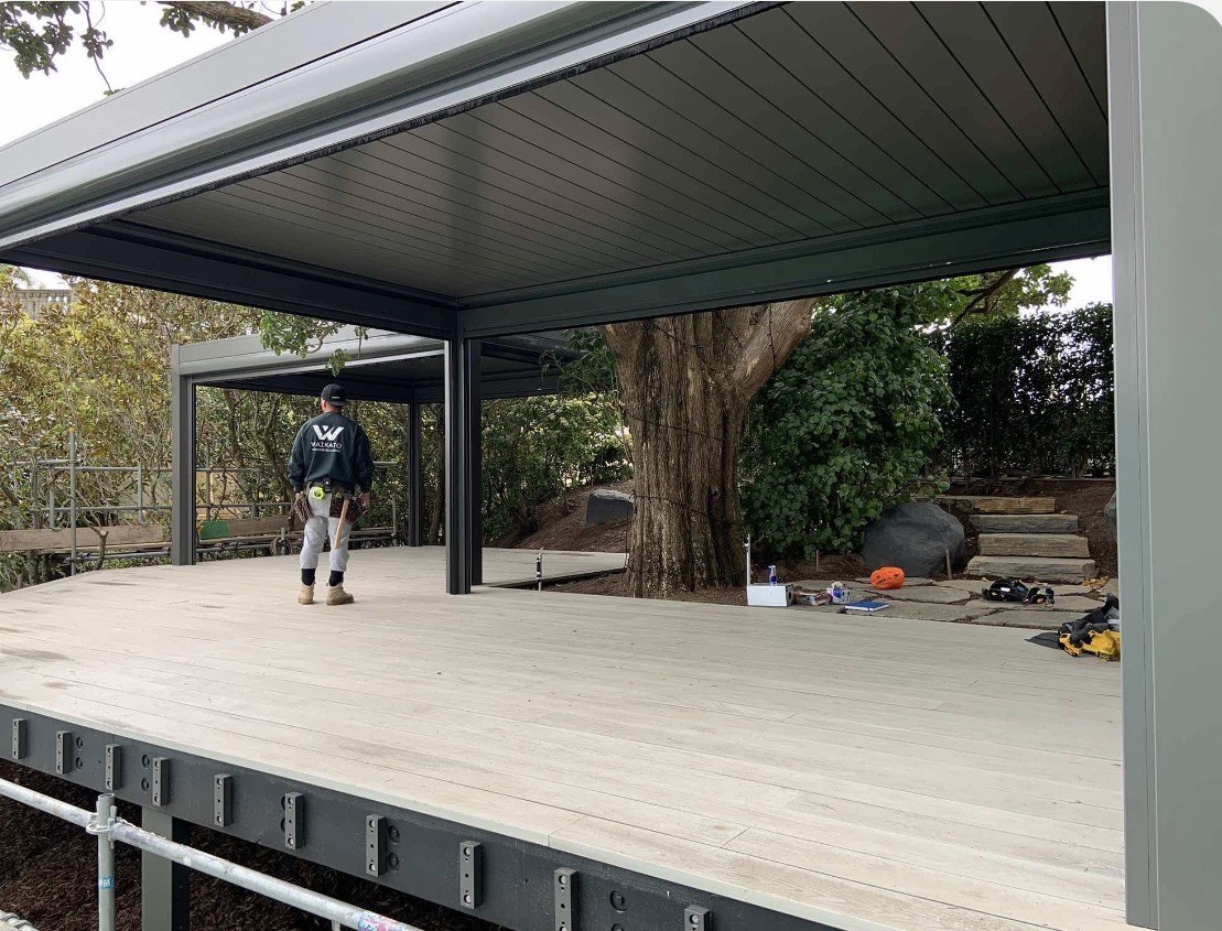 Twin louvred pergolas and composite decking around established trees in Mission Bay, Auckland