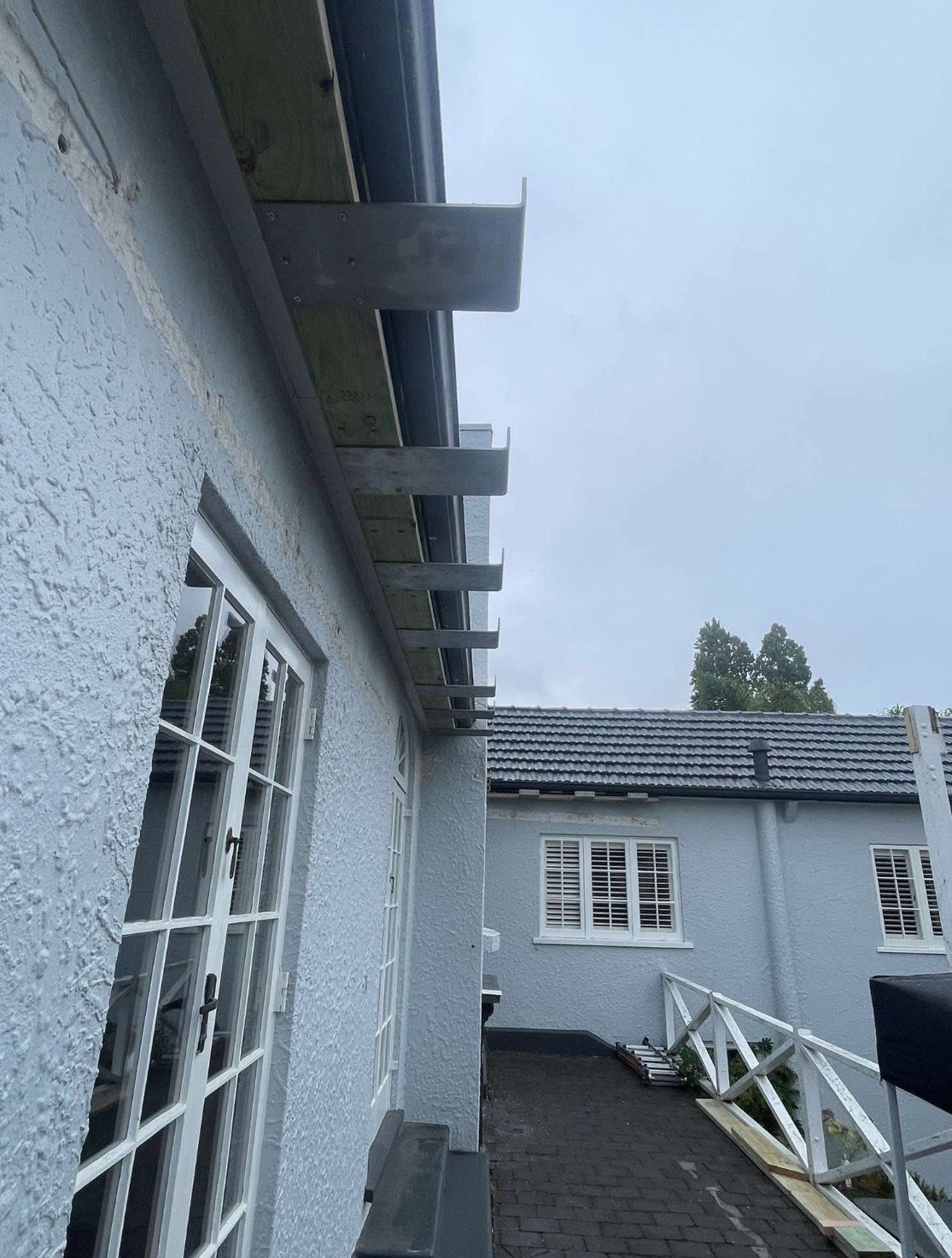 Pergola mounting brackets installed along the existing home on River Road, Hamilton