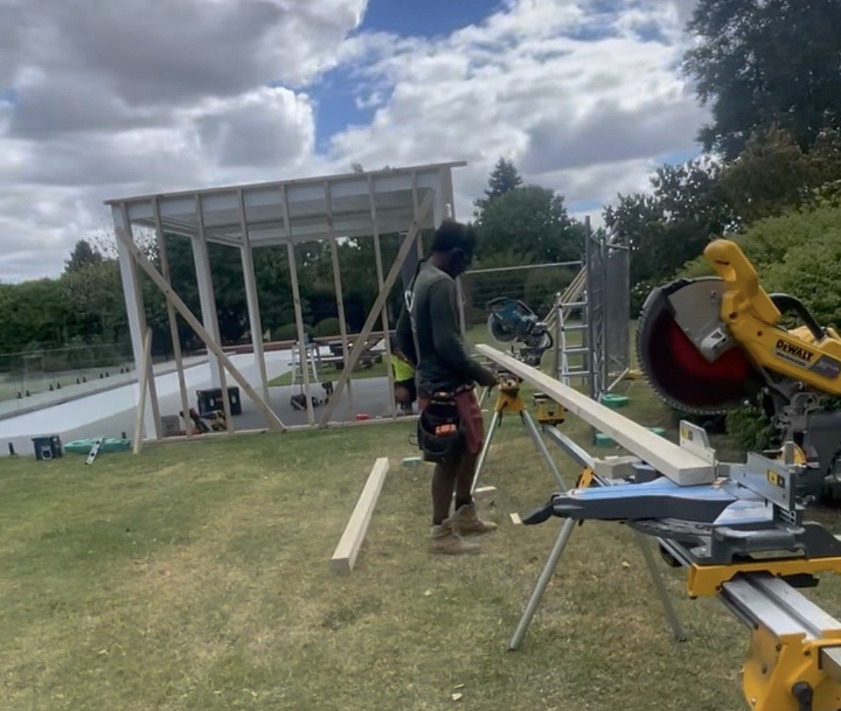 Preparing timber during poolhouse framing.