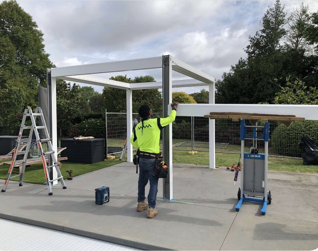 GRIT assembling the pergola posts and beams.