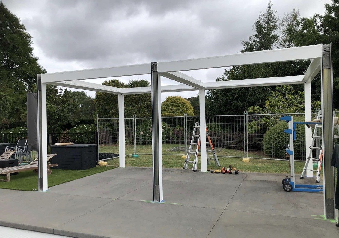 The pergola frame in place before the roof louvres.