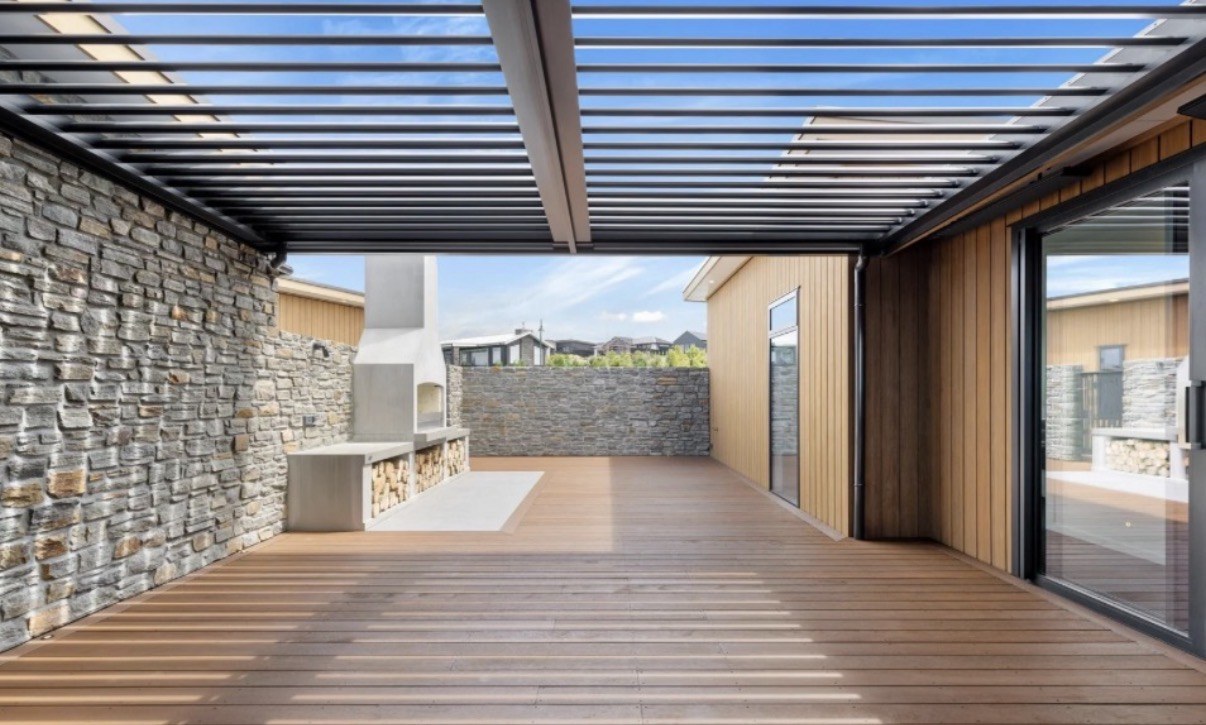 Twin-bay motorised louvred pergola overlooking Lake Taupō